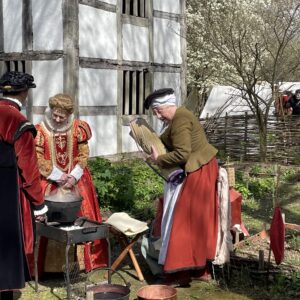 Tudor dressed reenactors outside the medieval town house at Avoncroft museum at the International Living History Festival