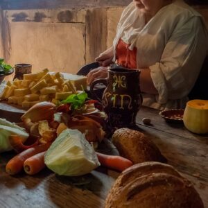 17th century cooking lady with food in the medieval house
