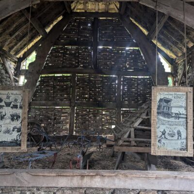 boards hanging from barn beams with images and information history of threshing