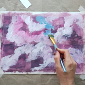 A person painting an abstract image