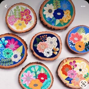 wood slices decorated with flowers using felt pens